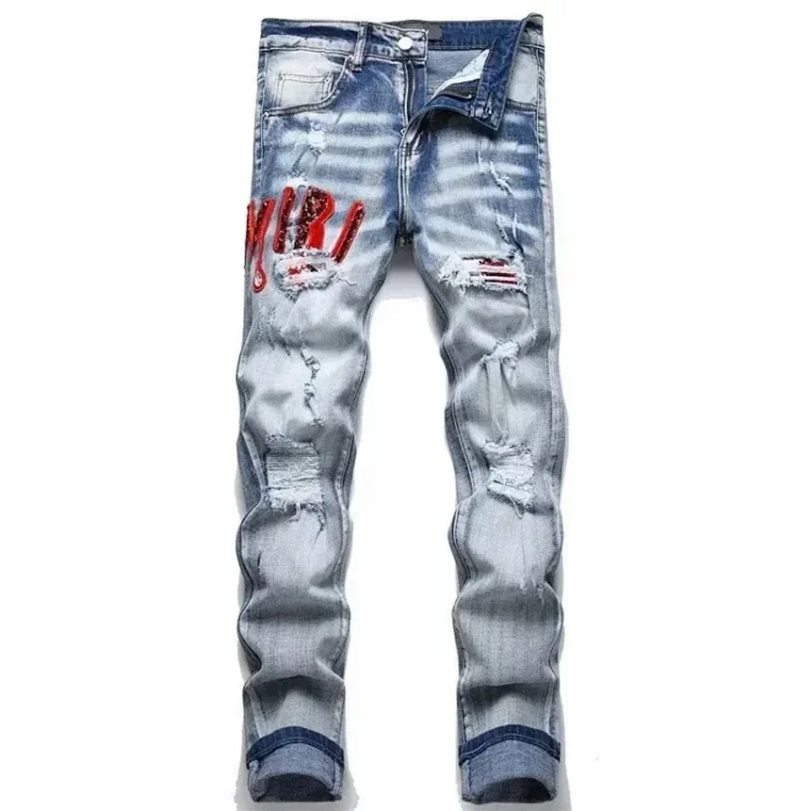 Full-length light-wash distressed denim trousers on a white background