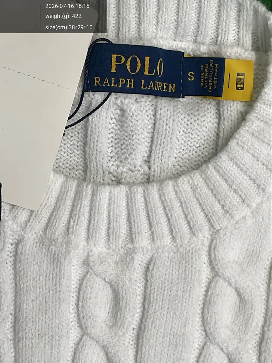 Close-up of the cable-knit texture and neck area in a warehouse QC photograph